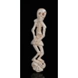 19th Century bone carved skeleton group, of a standing skeleton above skulls, 10.5cm high