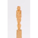 Early 20th Century novelty carved matchstick of a standing figure contained in a glass, cork sealed,