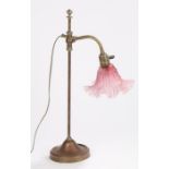 20th Century brass and copper reading lamp, with frilled puce glass shade and adjustable column,