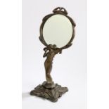 Art Nouveau style dressing table mirror, the circular bevelled mirror housed in a pierced scrolled