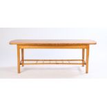 Mid 20th Century light oak coffee table, the shaped top raised on square tapering legs united by a