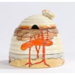 Clarice Cliff Bizarre Coral Firs pattern honey pot, of bee hive form and with bee finial to the lid,