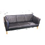 Late 20th Century three seat settee, with black leather cushions, raised on square chamfered legs