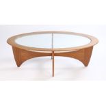 G-Plan Astro oval coffee table, with plate glass top, united by shaped legs and stretchers, the