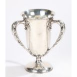 Cartier sterling silver trophy cup, with three acanthus leaf and scroll cast handles,, on a