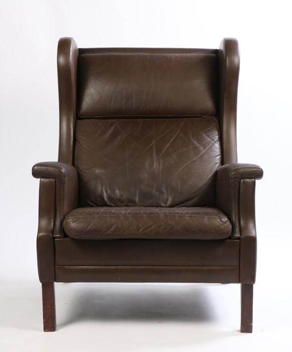 Late 20th Century brown leather wing back armchair, raised on square legs