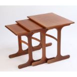 Nest of three mid 20th Century teak occasional tables, on chamfered supports and splayed feet, the