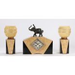Art Deco cream and black marble mantel clock garniture, the clock pediment with elephant and