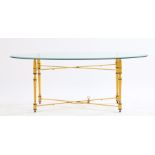 Glass coffee table, the oval glass top above a 19th Century yellow painted metal hinged base,