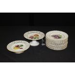 porcelain service, to include a set of twelve plates each with a different fruit and lattice edge,