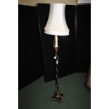 Standard lamp with candle effect stem above a column form central section and gadrooned foot