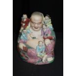 Chinese porcelain buddha, seated with smaller figures around, 30cm high