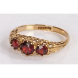 9 carat gold ring the head set with three garnets ring size M