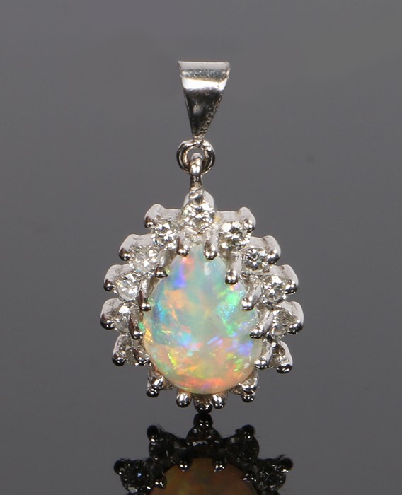 18 carat white gold diamond and opal pendant, with a pear cut opal and diamond surround, 19mm long