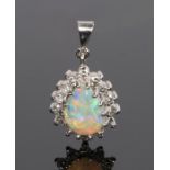 18 carat white gold diamond and opal pendant, with a pear cut opal and diamond surround, 19mm long