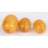 Three amber style beads, total weight 13.9 grams