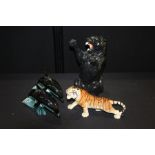 Decorative panther figure, 36cm high, together with a tiger and a pair of Poole pottery dolphins, (