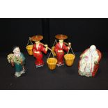 Collection of Oriental figures, to include a pair carrying baskets, a figure holding grapes and a