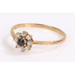 9 carat gold ring, with a central sapphire and flower head design, ring size Q