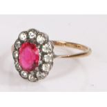 9 carat gold ring the silver head with oval red stone surrounded with zircons ring size L