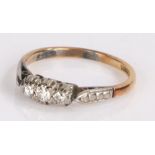 18 carat gold ring with platinum pierced shoulders leading to the three platinum mounted diamonds