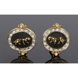 Pair of gilt metal earrings, with a leopard on the black ground