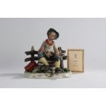 Capodimonte porcelain figure by Conte, depicting a tramp seated on a bench feeding a bird, with