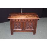 17th Century style oak coffer above a carved panel front, 83cm wide