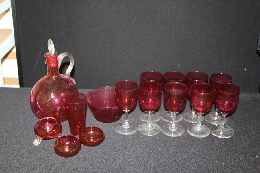 Cranberry glass, to include carafe, nine wine glasses, beaker, bowl, three salts (qty)