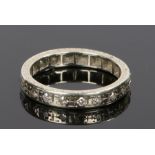 Diamond set eternity ring, with a row of diamonds surrounding the eternity ring in white metal, ring