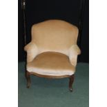 French style armchair, upholstered in a taupe material, with serpentine front seat, on cabriole