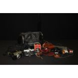 Cameras. to include Olympus OM-1, Agfa, Leidolf Lordox, together with a bag and accessories,