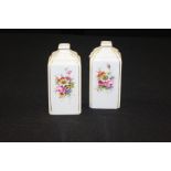 Pair of Royal Worcester porcelain scent bottles, decorated by Ernest Barker, signed “W” to the