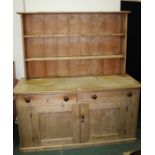 Victorian pine dresser, the plate rack with two shelves, the base with two drawers and two