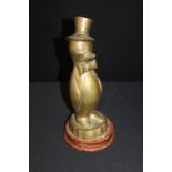 Novelty brass money pot as penguin on wooden plinth.36cm high.