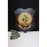 Heraldic shield panel, Can We Do You Now Sir?, together with a frog door stop, (2)