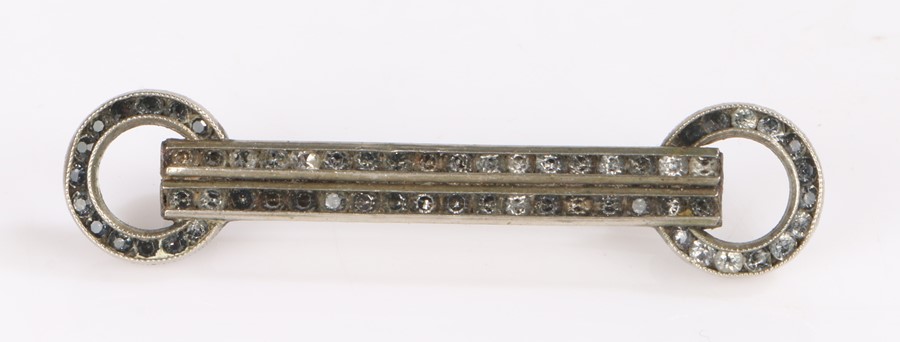 White metal bar brooch the straight bar with circular ends and set with black stones. 4.75cm