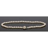 Pearl and 9 carat white gold necklace, the row of pearls with a 9 carat white gold pearl set