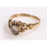 9 carat gold ring the scroll shoulders with a smoky quartz to the head, ring size K 1/2