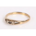 9 carat gold ring, the shank divides to either side of the head which is set with a central sapphire