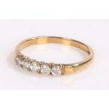 9 carat gold ring the band set with five cubic zirconia, ring size M 1/2