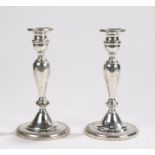 Pair of American sterling silver candlesticks, with gadrooned sconces and loaded bases, 23cm high