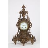 19th Century French brass mantel clock, the foliate cast urn form pediment above a pierced scroll