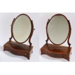 Near pair of 19th Century mahogany toilet mirrors, the oval mirror plates held within a pair of