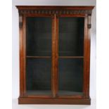 Victorian rosewood bookcase, the gothic pediment above two glazed doors, opening to reveal four