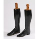 Pair of carved wooden model boots, with stud decoration, 30cm high