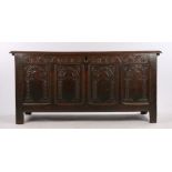 Georgian oak coffer, the hinged lid above four arch carved panels, on block feet, 143cm wide
