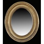 Regency wall mirror, of small proportions, the original oval mirror plate with a bead and moulded