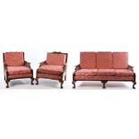 Bergere suite, consisting of three seat settee and two armchairs, with puce foliate upholstery,