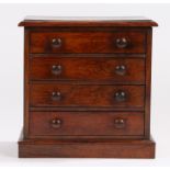 Victorian rosewood miniature chest of four long drawers, with turned handles, on a plinth base, 27.